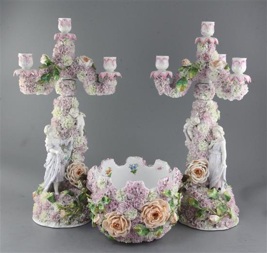 A pair of German floral encrusted porcelain three branch candelabra and a matching monteith, late 19th century, candelabra 51.5cm